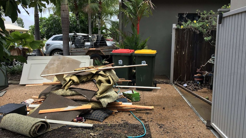 Rubbish outside a house as the mop-up starts at a house in Townsville.