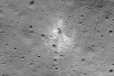 A grey image of the moon's surface, with a faint splodge in the middle, which is where the lander crashed.