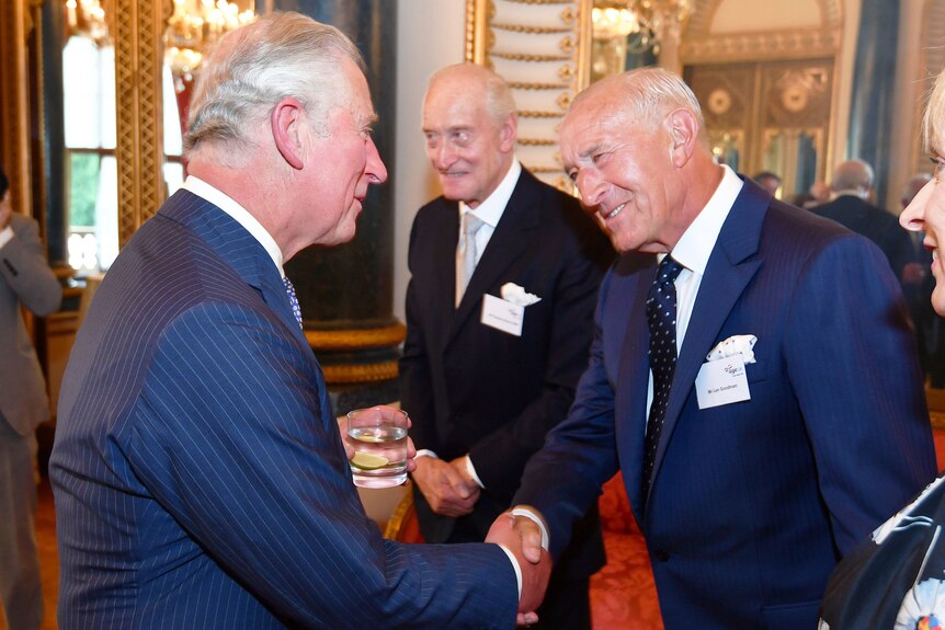 Two men in suits shaking hands