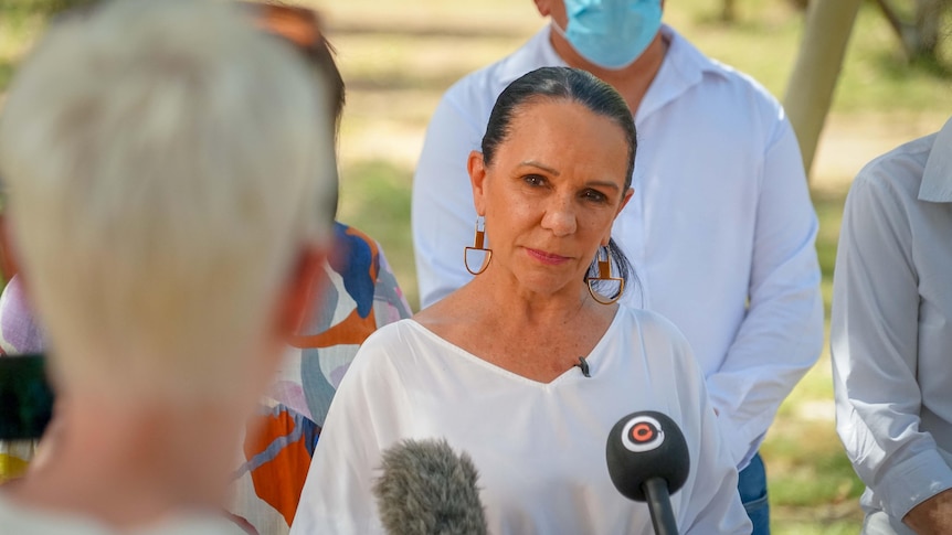 photo of Linda Burney with her hair back in a ponytail wearing a white shirt
