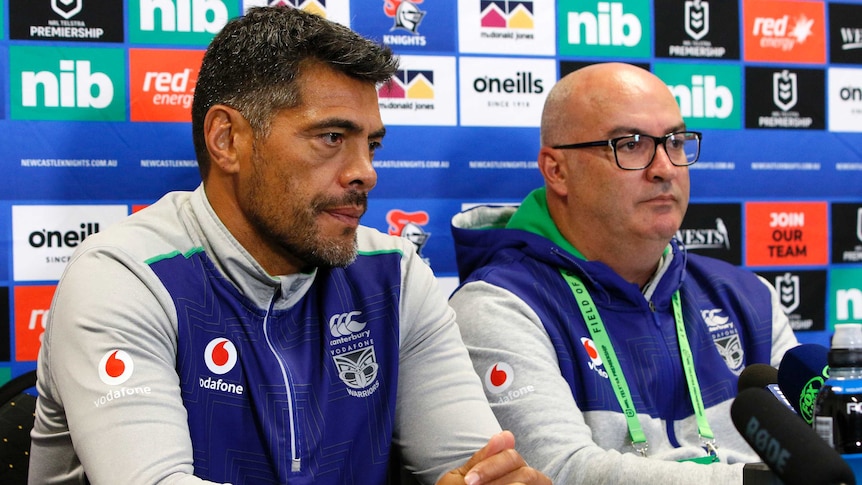 A rugby league coach and his team's chief executive sit at a desk during a press conference.