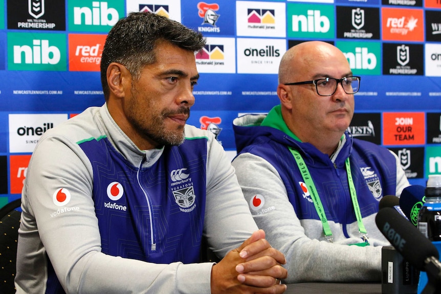 A rugby league coach and his team's chief executive sit at a desk during a press conference.