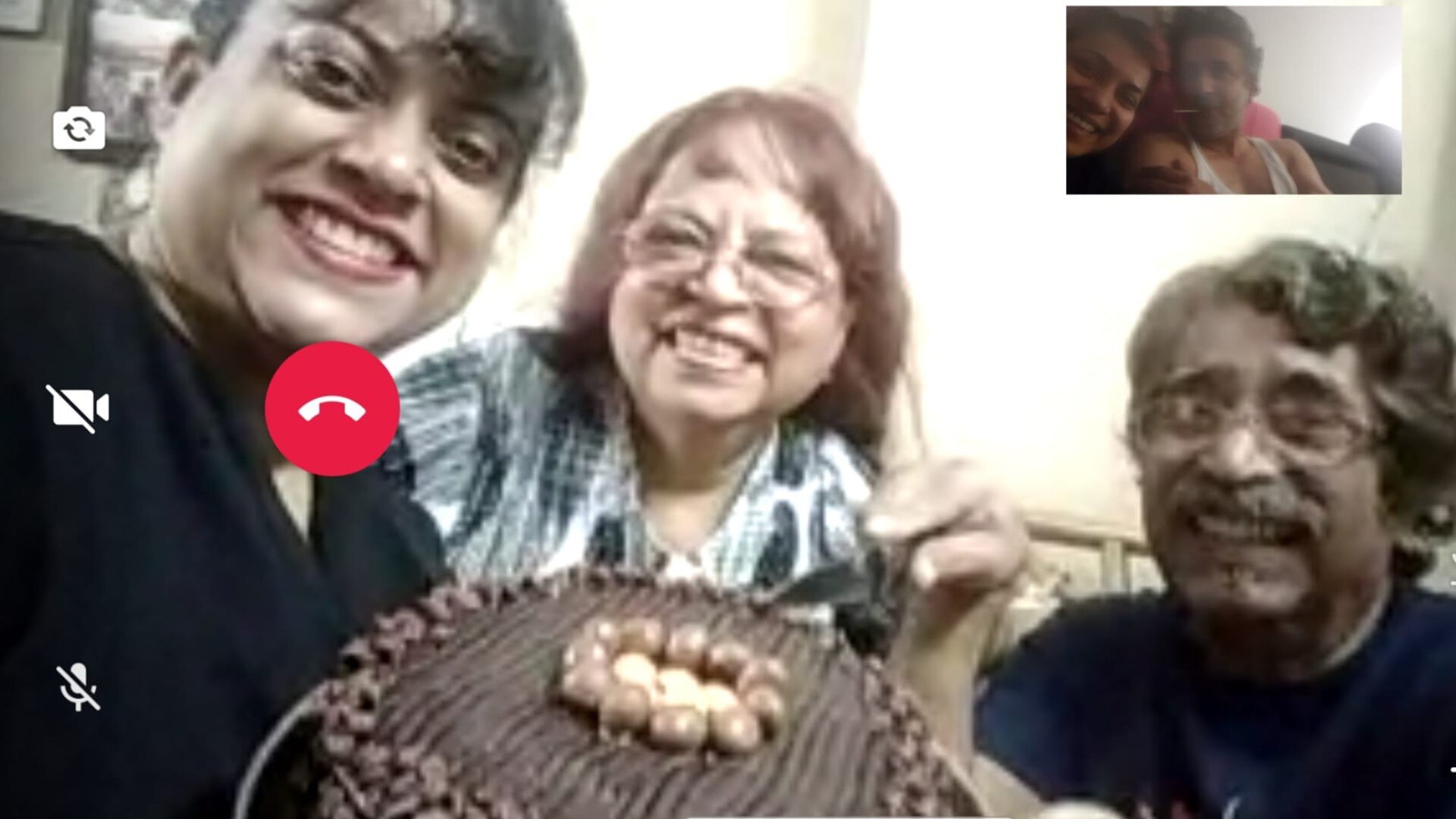 three people smile on a skype phone call with two people inset