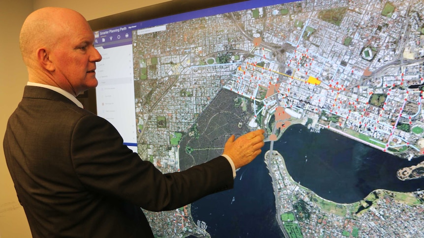 City of Perth CEO Martin Mileham reviews a map of Perth showing traffic hotspots.