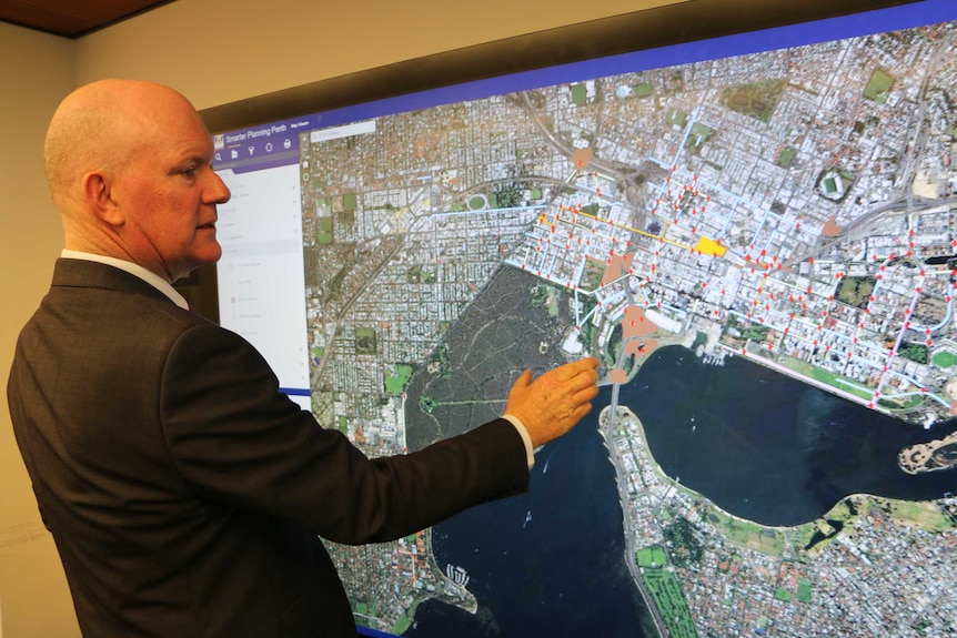 City of Perth CEO Martin Mileham reviews a map of Perth showing traffic hotspots.
