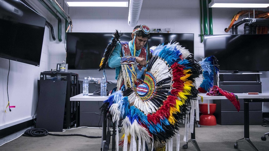 Colour photo of Kenneth Thomas Shirley of Indigenous Enterprise getting ready in office space.