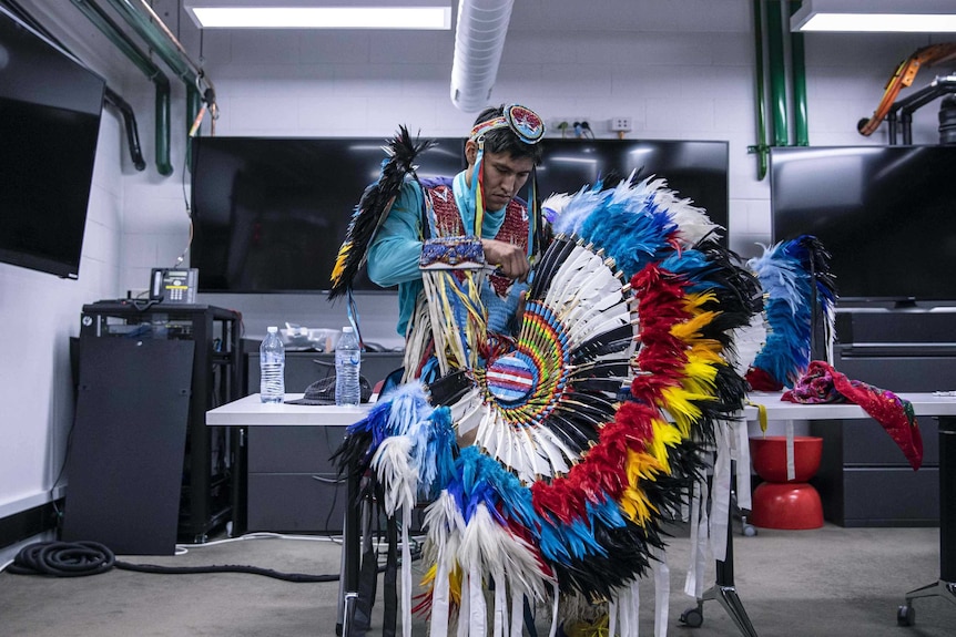 Colour photo of Kenneth Thomas Shirley of Indigenous Enterprise getting ready in office space.