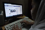 Indian woman logs onto Facebook
