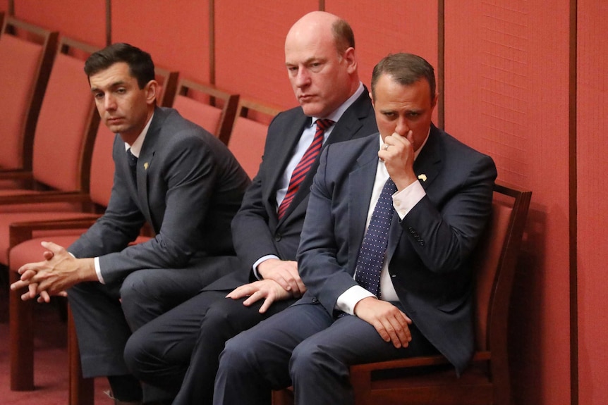 Trevor Evans and Trent Zimmerman sit transfixed as Dean Smith speaks. Tim Wilson is in tears