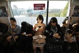 A woman sits in a women's only passenger carriage on the tokyo subway.