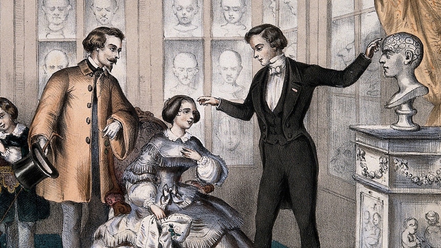 An 1800s colour illustration of a man inspecting a woman's head, as another man looks on, surrounded by plaster heads