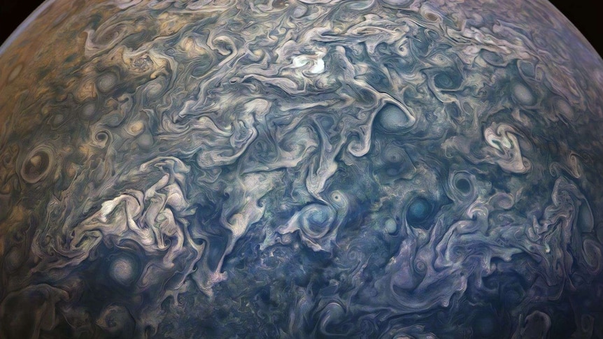 A series of blues, greens and purples swirl over a spherical surface.