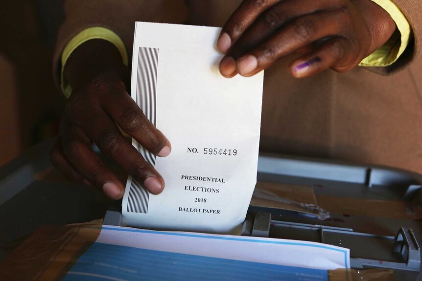 A man casts his vote at a polling station in Harare.