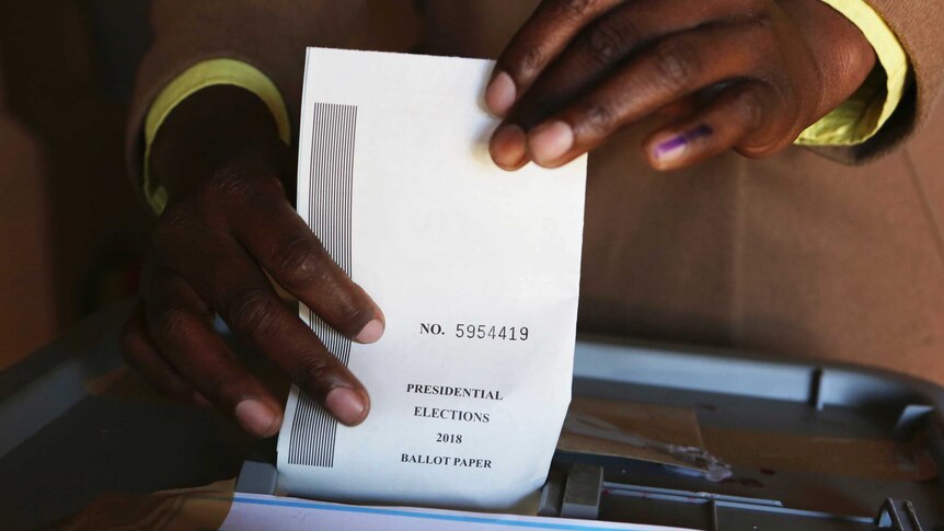 A man casts his vote at a polling station in Harare.