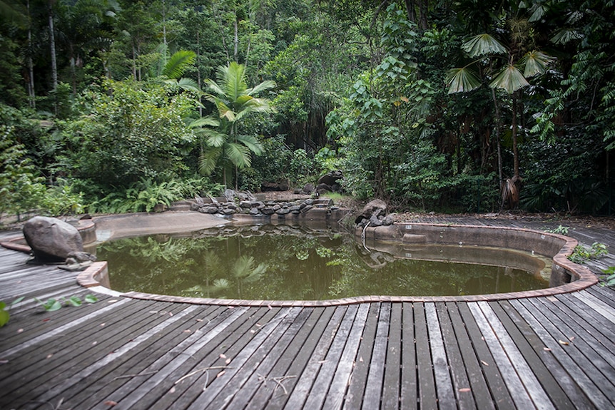 Water inside one of the resort's swimming pools has turned brown and the timber deck surrounding it has begun to rot.