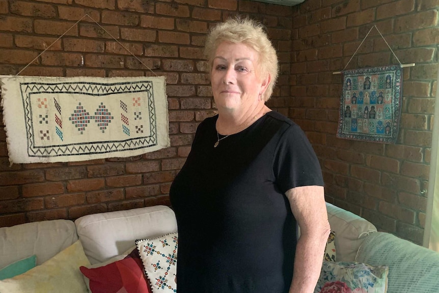 Sue Shearer stands in the living room of her Darwin home.