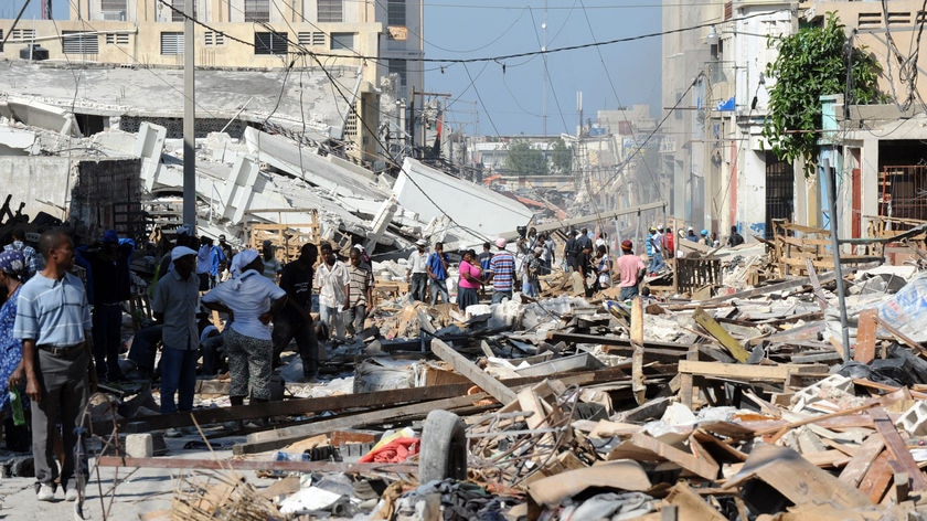 Locals walk in a devastated street in Port-au-Prince