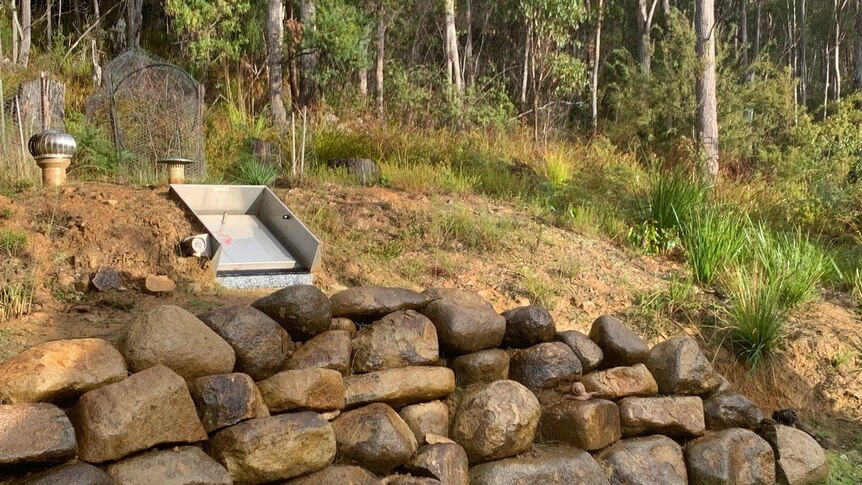 A stainless steel hatch in a sloped landscape