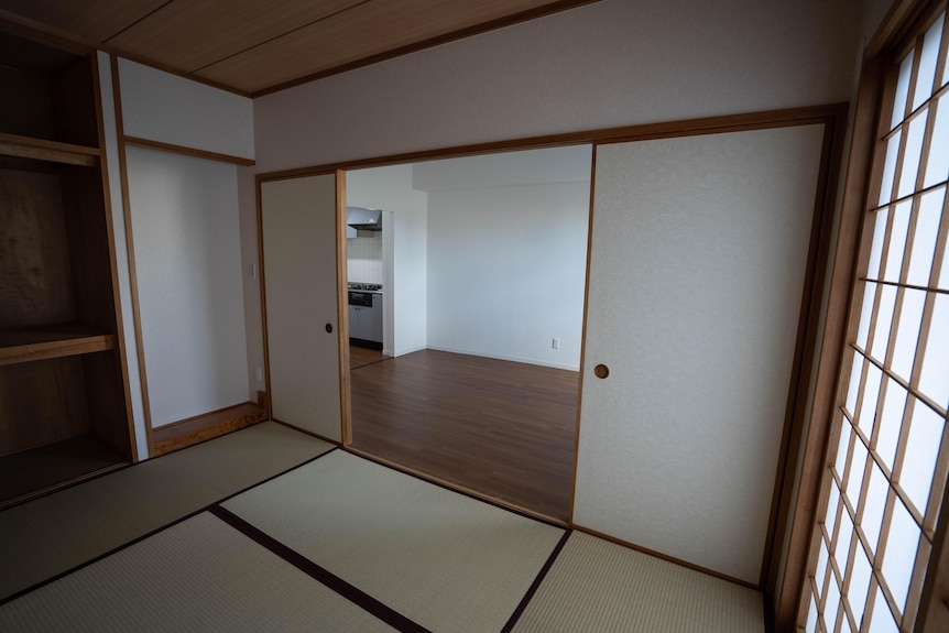 a room with tatami mats on the floor and sliding doors