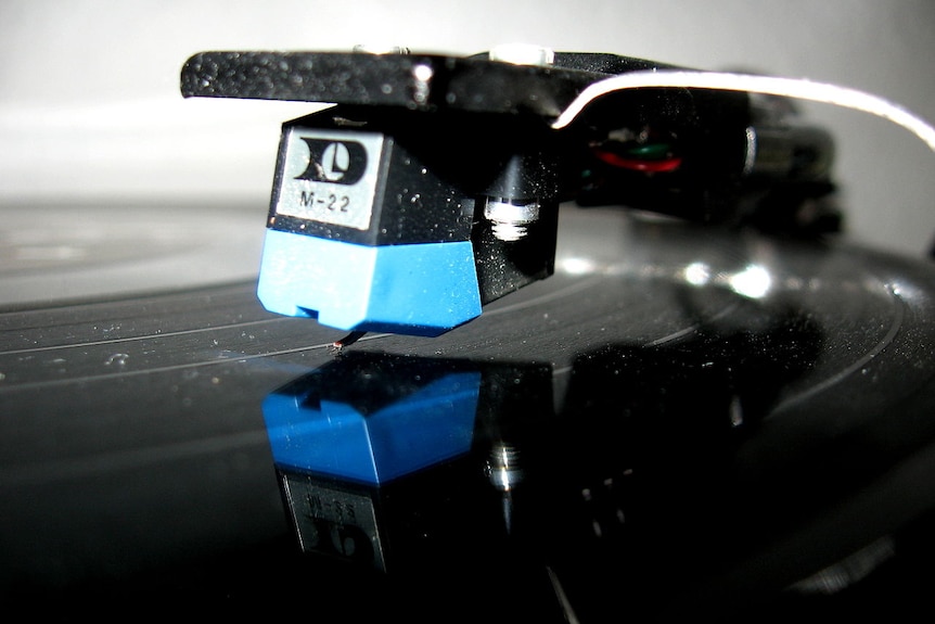A close up image of a record player on the record
