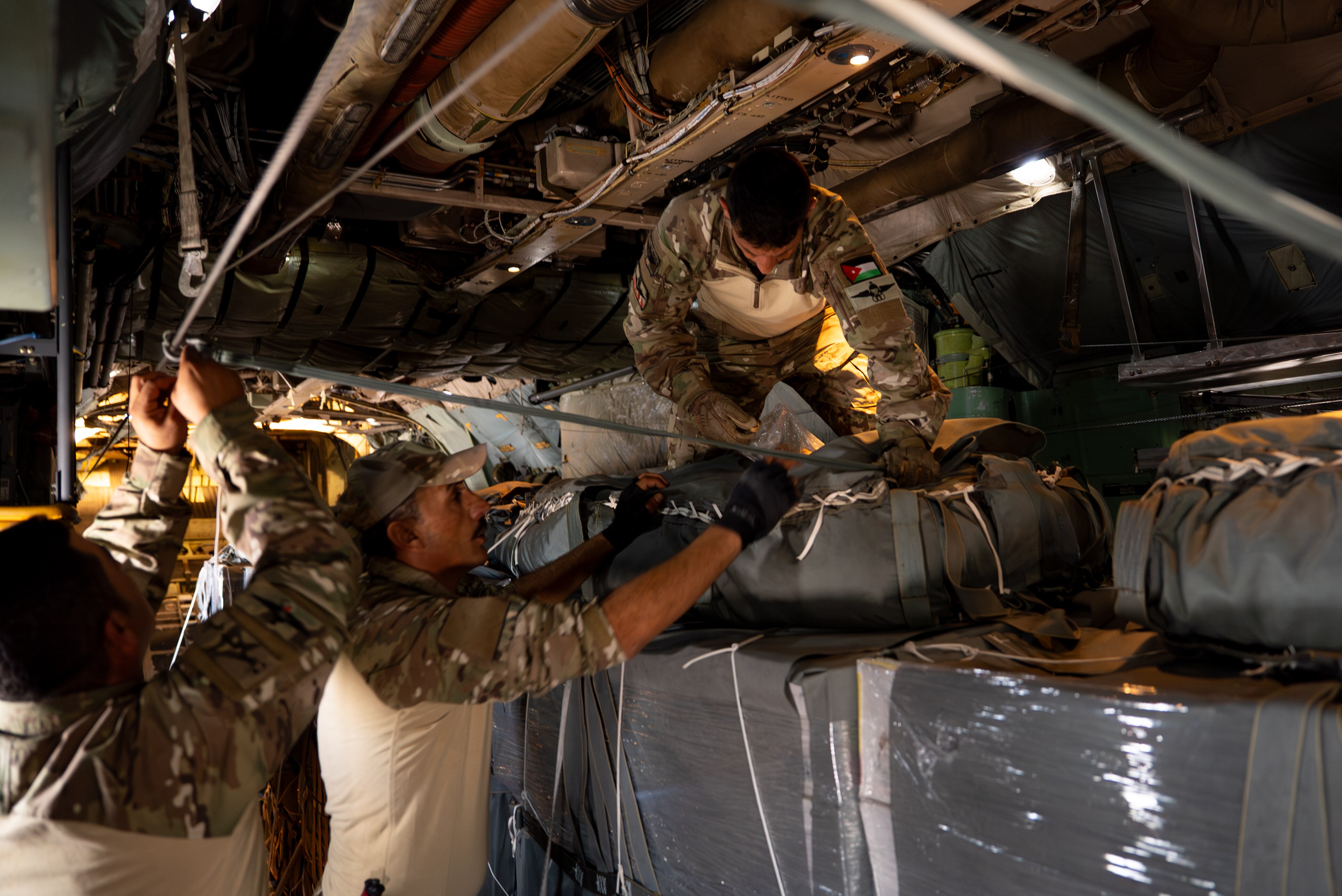 Aircraft crews prepare aid to drop for starving people in Gaza.