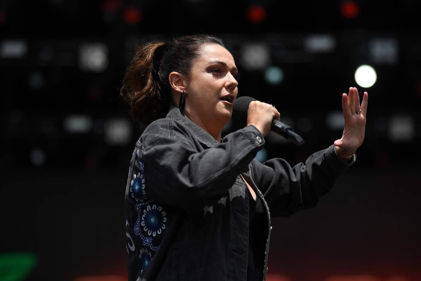 A woman speaks into a microphone