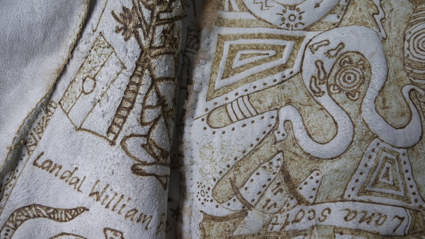 a close up of a possum skin with a design burnt into it