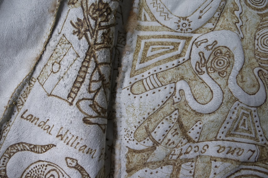 a close up of a possum skin with a design burnt into it