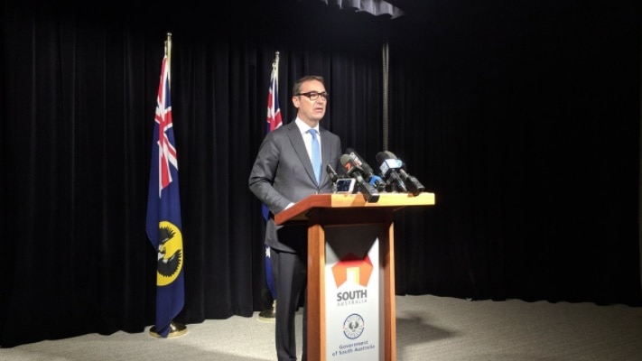 Steven Marshall at a podium for a news conference.