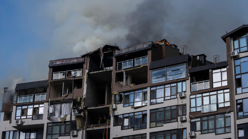 Smoke billows the air from a residential buildings following explosions, in Kyiv.