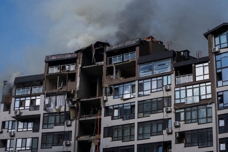 Smoke billows the air from a residential buildings following explosions, in Kyiv.