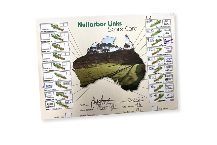 A golf score card with some signatures on it.