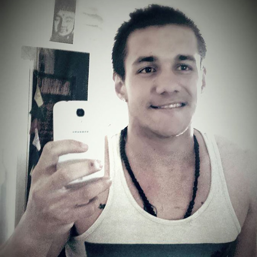 24-year-old Landon Delinecort with short-cropped hair in a singlet taking a selfie