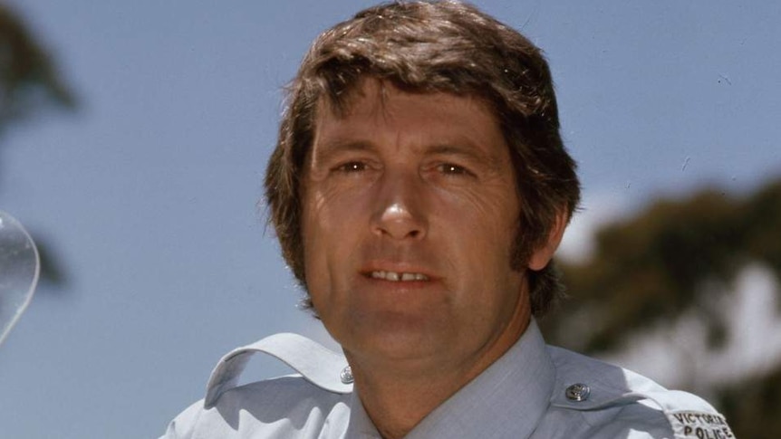 Actor Paul Cronin in police uniform on a motorbike in a scene from Matlock Police.