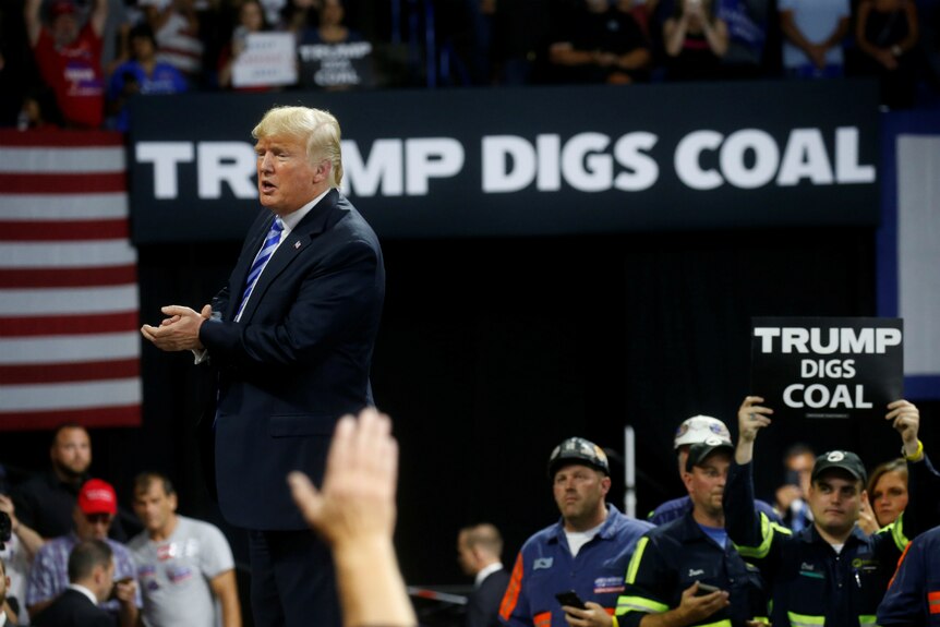 United States President Donald Trump acknowledges coal miners.