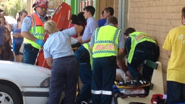 Police say an empty white sedan rolled onto the footpath outside a shopping centre and hit the man.