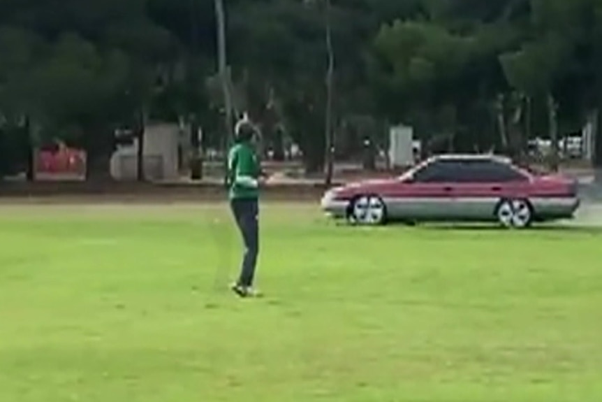 A stolen car crosses an Adelaide playing field.