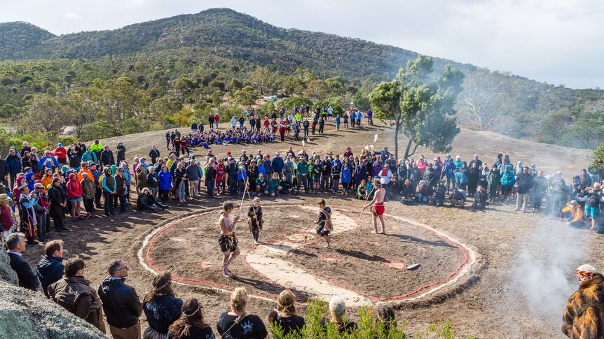 Spectators in a large circle watch the Wadawurrung ceremony.