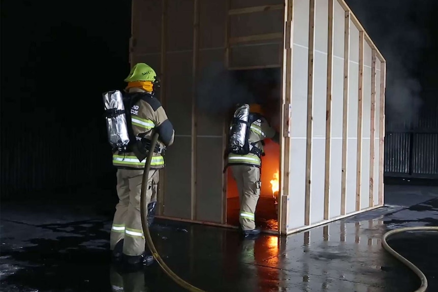 Queensland Fire and Rescue Service investigators recreate a house fire as part of the investigation.