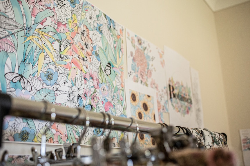 An image showing designs on the wall of a studio, full of bright colours of the Australian rainforest.