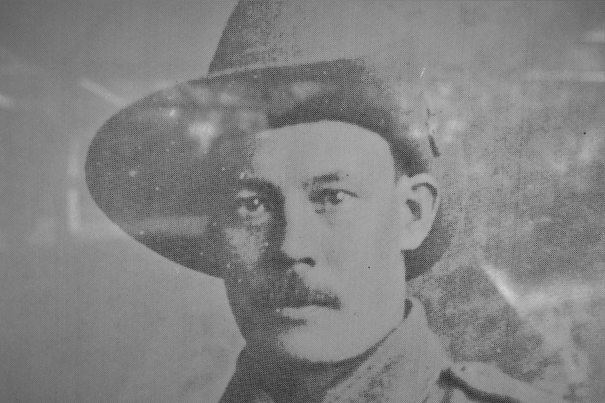 a man in military uniform is looking into the camera