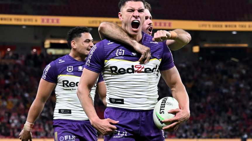 A man celebrates after scoring a try in a rugby league match