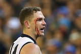 Geelong's Joel Selwood comes off the ground with a cut to his eye against the Kangaroos at the MCG.