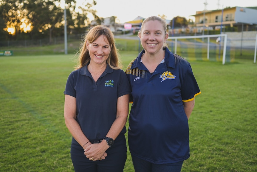 Tracy and Belinda on a soccer pitch.