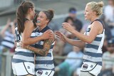 Geelong players celebrate an AFLW goal against Collingwood.