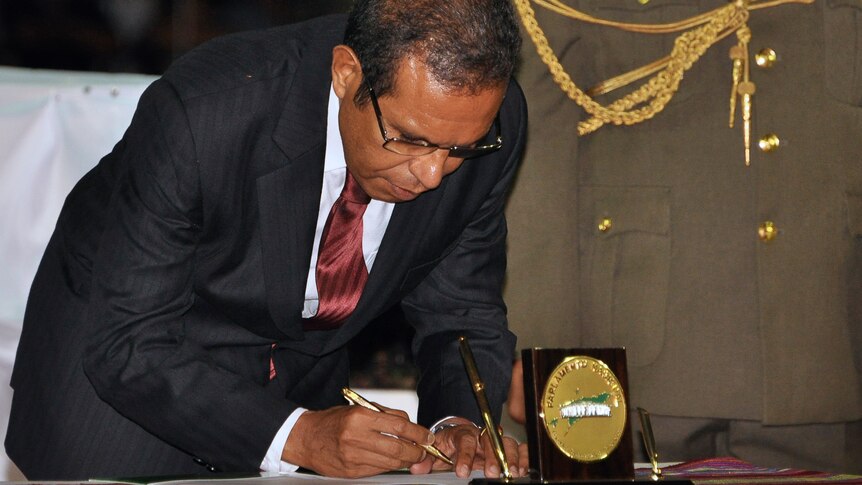 East Timor president Taur Matan Ruak signs the register during the handover of power in Dili.