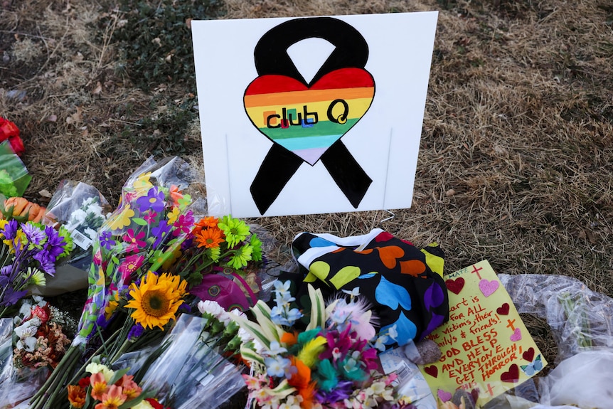 Floral tributes are placed in memory of the victims after a mass shooting at the Club Q gay nightclub.