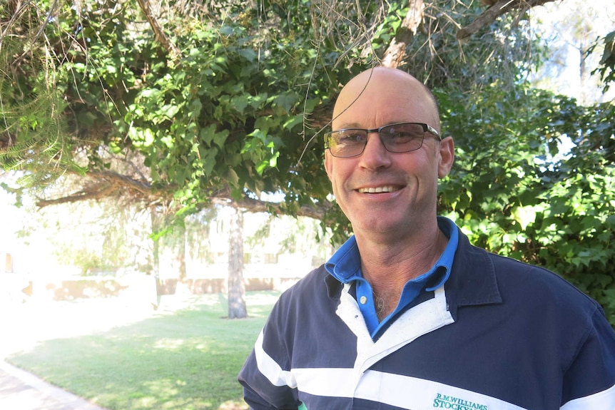 Irrigator Trent Gardiner standing in front of a bush outside Coleambally Irrigation