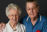 David and Helen Richards pose together with an old WWII photograph.