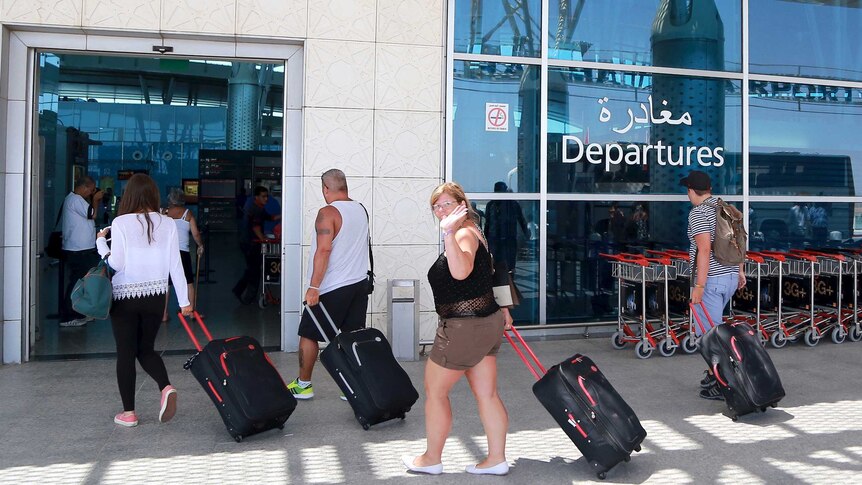 Tourists queue to leave Tunisia at the Enfidha international airport